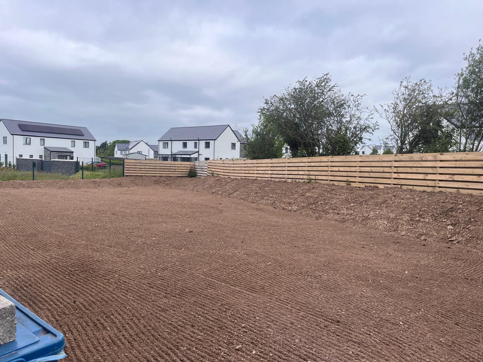 New-build garden before: bare, uneven topsoil graded ready for seeding