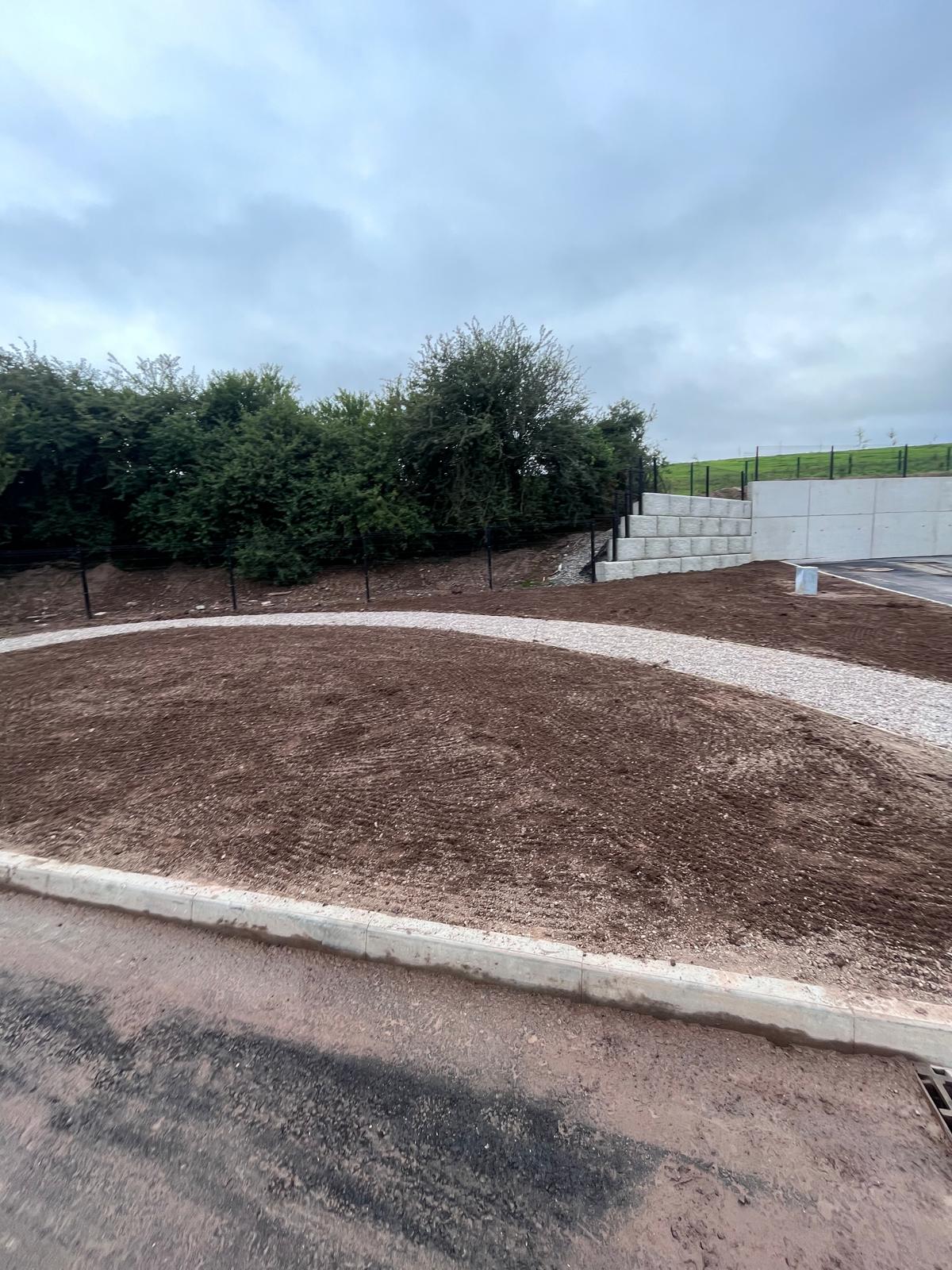 Graded ground, kerbing & retaining wall